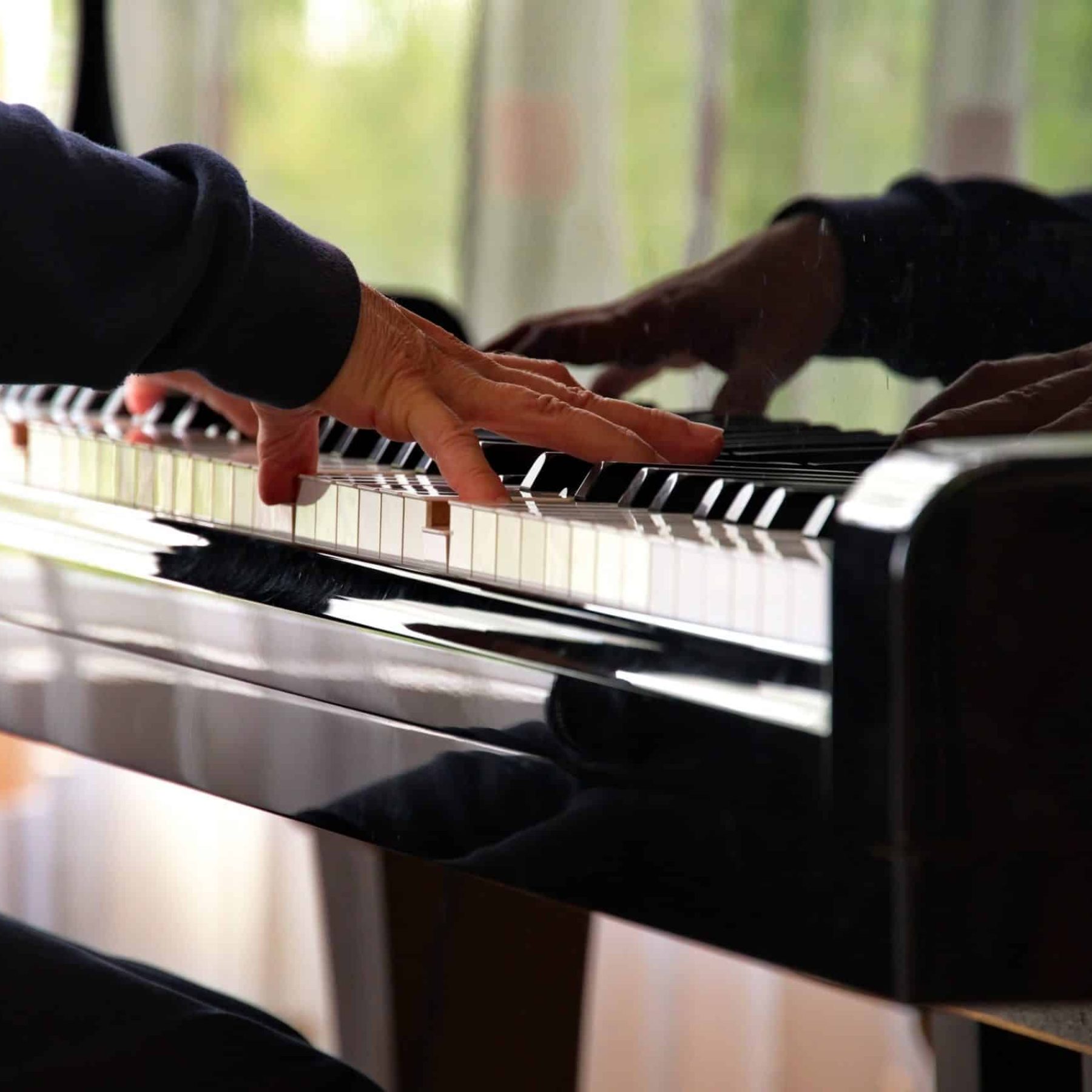 close-view-of-woman-hand-on-piano-keys-while-playi-2024-01-26-03-08-01-utc-min