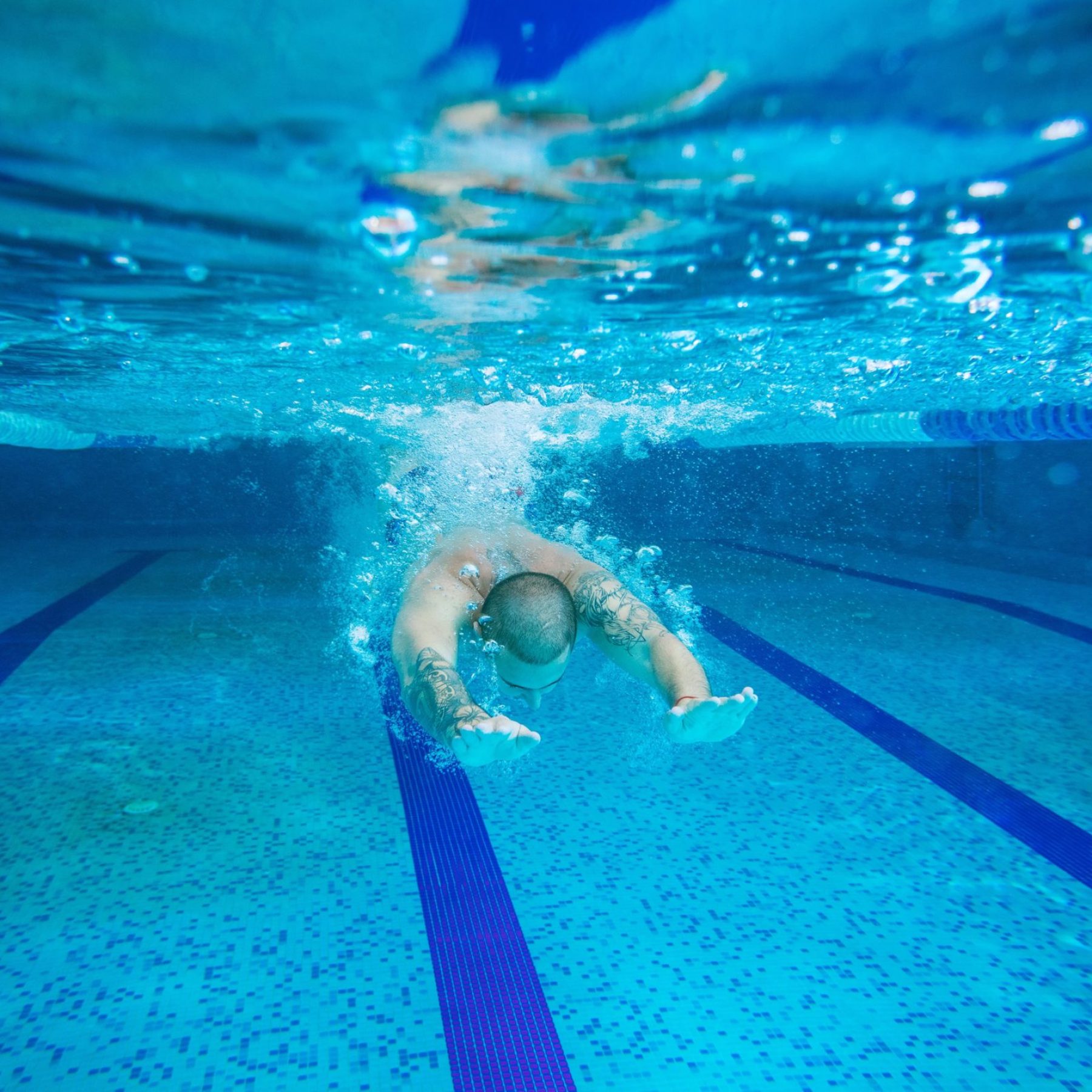 young-man-swimming-underwater-2025-01-09-05-15-55-utc-min